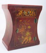A red Chinese altar cabinet with chinoserie decoration, inverted sides and cupboard under single