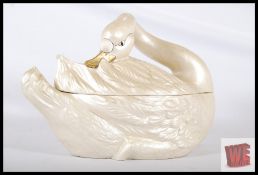 A large continental pottery Swan decorative tureen ornament. 43cm long.