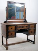 A Jaycee carved oak dressing table in the 18th century style. Stoon on turned legs united by
