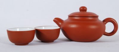 A mid 20th century Yixing Chinese teapot of small form having impressed markings in Chinese to base,