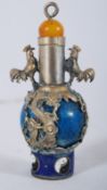 A Chinese blue glass snuff bottle having overlayed metal clasp mounts with amber top and cockerel