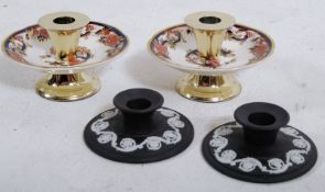 A pair of Masons Imari pattern candlesticks on brass plinths with brass candle holders together with