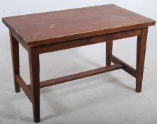 A solid pine heavy refectory dining table stood on square tapered legs with central stretcher