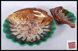 Two Majolica style studio pottery conch sheels with drip glaze design. The largest measuring 28cm