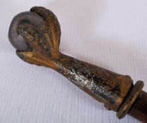 A decorative home made walking stick having a gilt metal ormulu claw handle with glass ball inset.