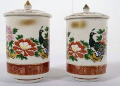 A pair of Japanese ceramic marriage canisters, with famille rose decoration. One larger than the