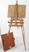 A 20th century artists folding easel together with an artists board. The easel being adjustable in