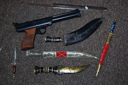 A Powerline 717 Rogers American air pistol, along with a quantity of ornamental daggers and knife,