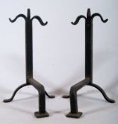 A pair of cast iron fire andirons with square pad feet. 37cm x 23cm.