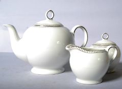 A Royal Doulton teapot, sugar and cream set in the Paramount Platinum pattern (unused, and boxed)