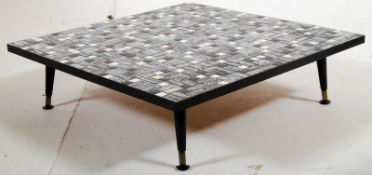 A 1970's retro mosaic low coffee table of square  form in many colours finished with black