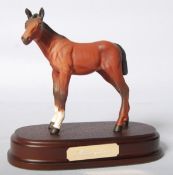 A Beswick foal 'Adventure' on a wooden plint, with model number 2876.