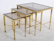 A vintage 1970's gilt metal and smoked glass nest of tables. 47cms High x 56cms Wide  x 46cms Depth
