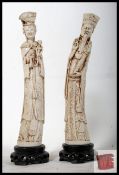 Two Chinese faux ivory plaster figurines with decorative design of man and woman, on plaster