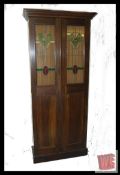 An Edwardian mahogany nightwatchmans  / railway bed cupboard. The cupboard doors featuring lead