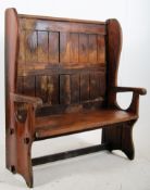 A 19th century large high back pitch pine pew having shaped elbow rests with planked seat and