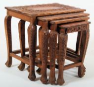 A Chinese Quartetto nest of tables with carved legs with peripheral stretchers on frieze frames with