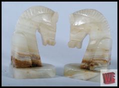 A pair of 1950's Onyx stone bookends in the form of Horses set on squared terraced bases. 13cm