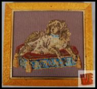 A framed and glazed 20th century woolwork sampler depicting dog on cushion. Finished in a birds