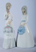 A pair of Lladro figures - both of girls holding bonnets. 24cm tall.