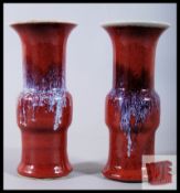 A pair of 19th century Chinese red glaze porcelain Gu-shaped vases. 15cm tall.