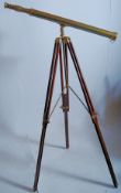 A large 19th century style mahogany and brass field telescope. The mahogany triped stretcher