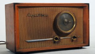 A Regentone vintage valve radio titled 'DW2' encased in walnut with a circular dial to the front.