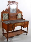 An Edwardian satin walnut marble top washstand,.Turned legs with uniting tier supporting a chest