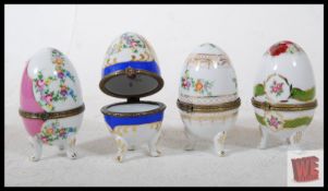 4 OC & Co ceramic Faberge style eggs, each variously decorated with flowers and figural panels