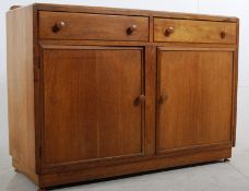 A 1940's Art Deco oak sideboard in the style of Gordon Russell. Inset plinth base with cupboard