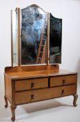 1930's Art Deco walnut batwing dressing table chest. Angular cabriole legs supporting a low chest of