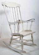 A Shabby Chic painted windsor style rocking chair. Sliegh runners supporting the deep seat and