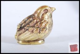 A brass vesta in the form of a bird with fully hinged middle. 5cm tall.