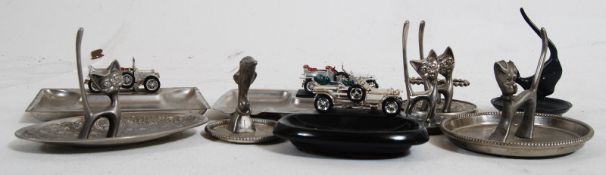 Two metal Lesney car ashtrays, together with one Lesney car ashtray with a china base, and siz metal