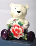 An Old Tupton Ware teddy bear money box in the Butterfly pattern. Boxed. 17cm tall.