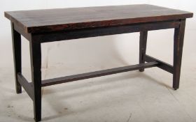 A solid stained dark pine heavy refectory dining table stood on square tapered legs with central