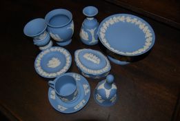 A good collection of Wedgwood blue jasperware to include urn, stem vase, trinket bowl with lid,