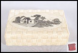 An Ox bone snuff box with decorative sail boat and house design. 9cm wide.