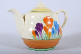A Clarice Cliff 'Crocus' pattern teapot within lemon and treacle borders. Clarice Cliff stamp to