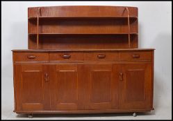 A 1970's retro oak sideboard / room divider in the Ercol manner. A series of cupboards and drawers