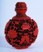 A 1960's Chinese Cinnabar red composition snuff bottle with carp and foliate decoration. 7cm tall.