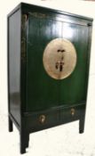 A 20th century Chinese green lacquered marriage cabinet. Stood on squared legs with drawers to