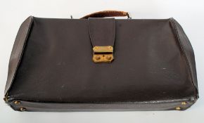 A vintage leather attache case with affixed leather handle to top.