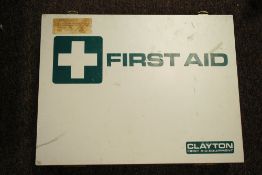 A retro Industrial wall hanging first aid box with contents.