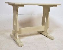 A 1920`s oak shabby chic painted refectory dining table. The lyre supports having shaped legs