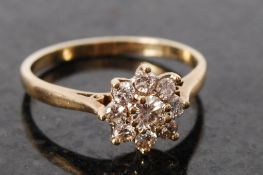 An 18 ct gold and diamond cluster ring, approx .50 points. The flower shaped ring being inset with