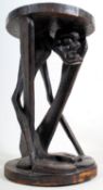 A 20th century large trival art African Makonde figural table stand. The square plinth base and top