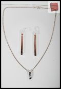 A Danish white metal silver pendant in a contemporary minimalist style marked 925 on curbed necklet