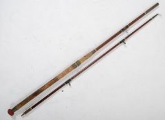 A vintage split cane fishing rod having brass and ceramic carriage eyes complete with linen cover