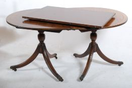 An Edwardian mahogany pedestal dining table. Reeded tripod legs with brass lion paw castors